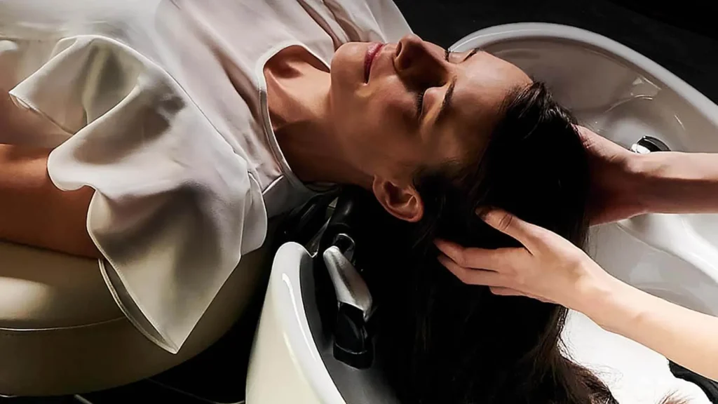 A man getting his hair cut at the salon