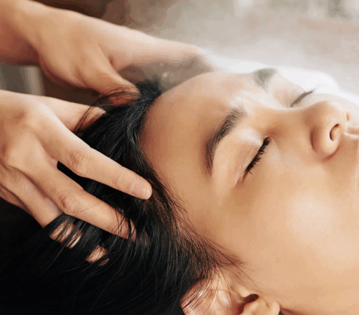 Person receiving a relaxing head massage treatment.