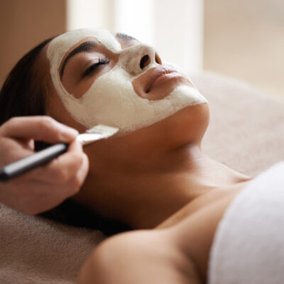 Woman receiving a relaxing facial mask treatment.