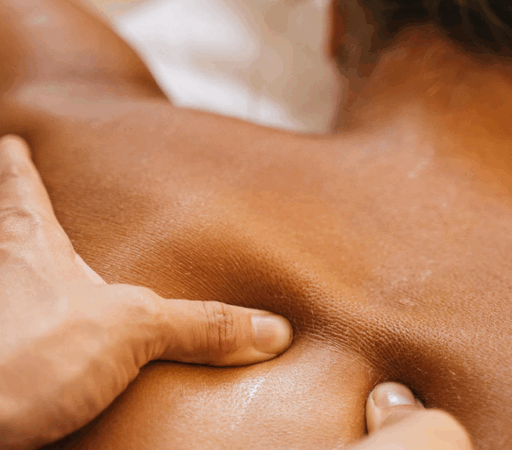 Person receiving a back massage therapy session.